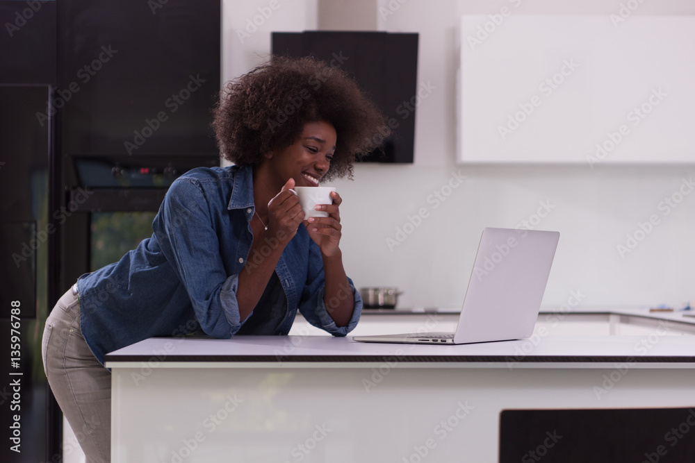 smiling black woman in modern kitchen smiling black woman in modern kitchen