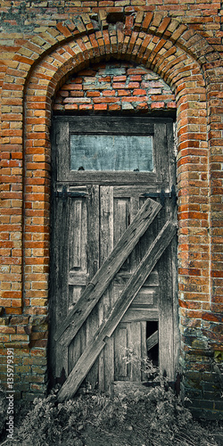 Old wooden door in an old brick building