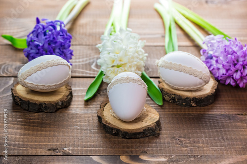 Beautiful Easter eggs with flowers hyacinths on the wooden background