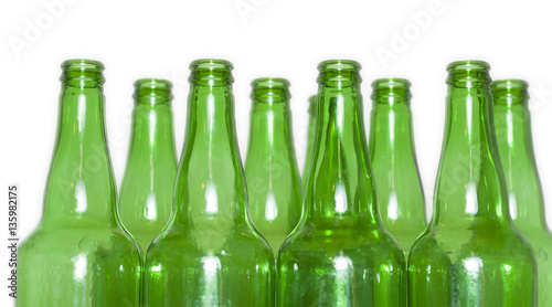 Row of open empty green bottles isolated on white background photo