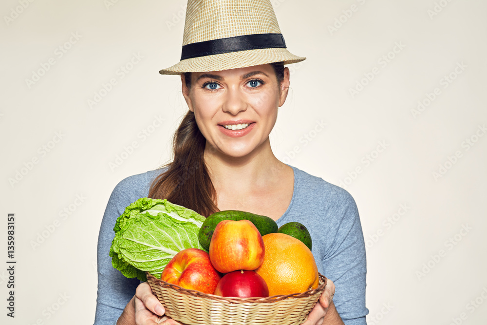 Smiling woman holding basket with fruit and vegetable. Smiling woman holding basket with fruit and vegetable.