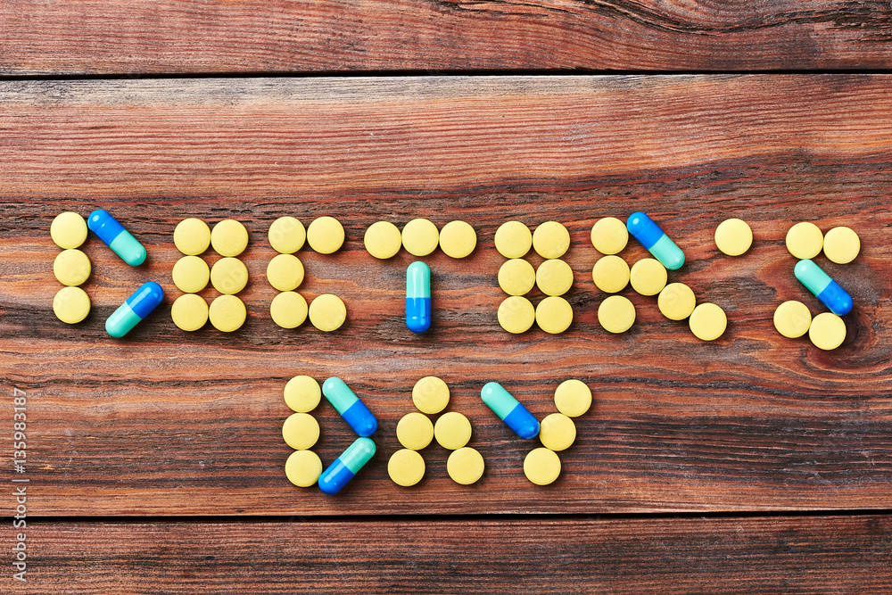 Pills on brown wooden surface. Best wishes on Doctor's Day. Pills on brown wooden surface. Best wishes on Doctor's Day.