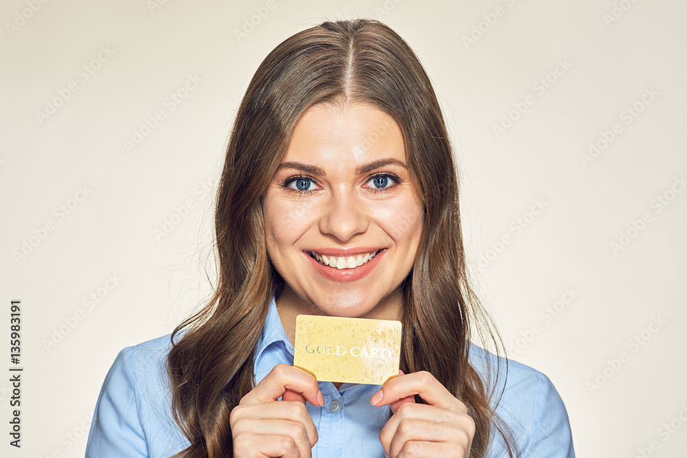 Smiling business woman holding credit gold card. Smiling business woman holding credit gold card.