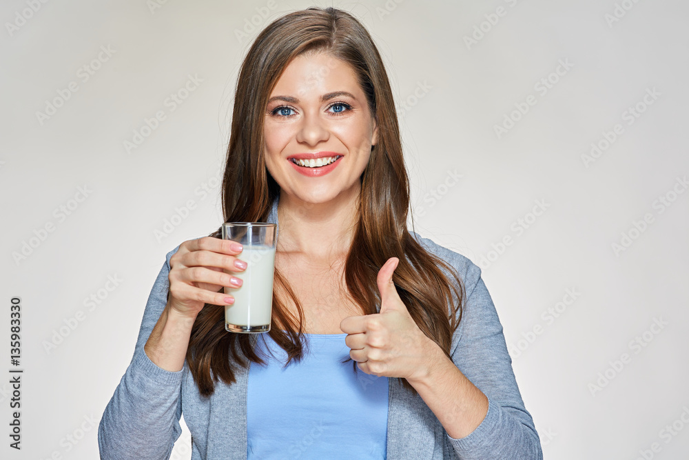Smiling woman holding milk glass shows thumb up. Smiling woman holding milk glass shows thumb up.
