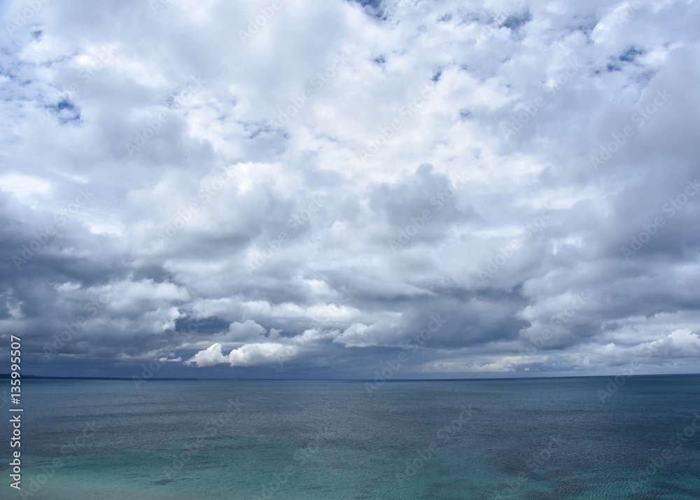 Gushing sea on a cloudy day. Horizontal view of dramatic overcast sky and sea. Fifty shades of blue.