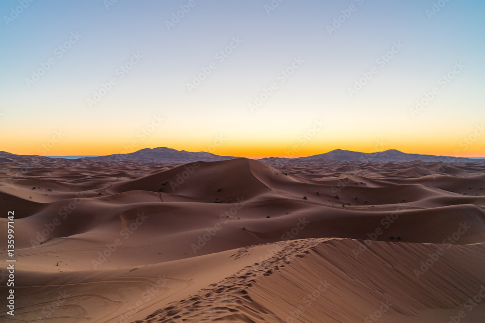the sun rises in the desert
