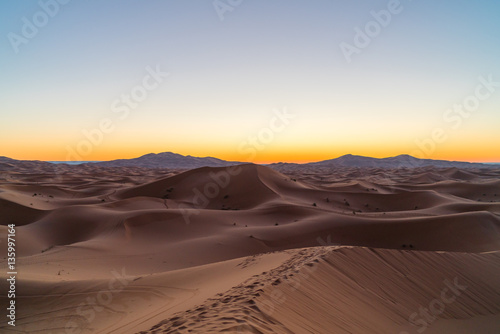 the sun rises in the desert  