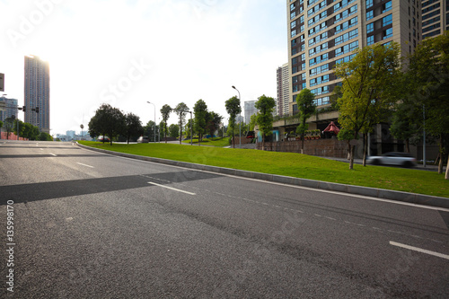 Empty road surface floor with City streetscape buildings