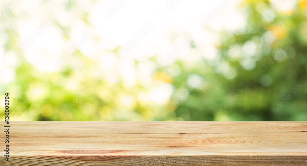 Empty wood table top on blur abstract green from garden in morning Empty wood table top on blur abstract green from garden in morning