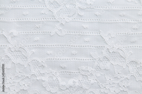 White lace with small flowers on the white background.