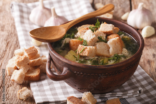 garlic soup with homemade croutons close up in a bowl. horizontal photo