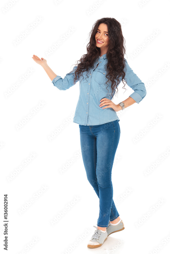 full body picture of a smiling casual woman presenting full body picture of a smiling casual woman presenting