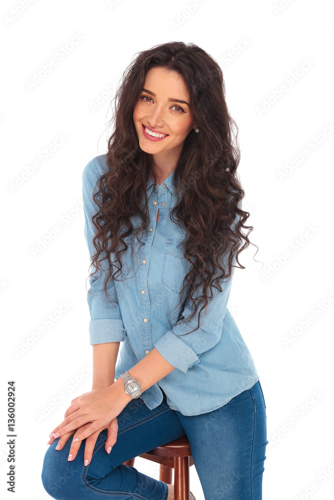 portrait of a seated smiling curly woman portrait of a seated smiling curly woman