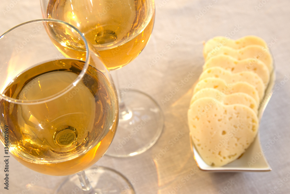 Heart shaped cheese and two glasses of wine. Valentine's Day Heart shaped cheese and two glasses of wine. Valentine's Day