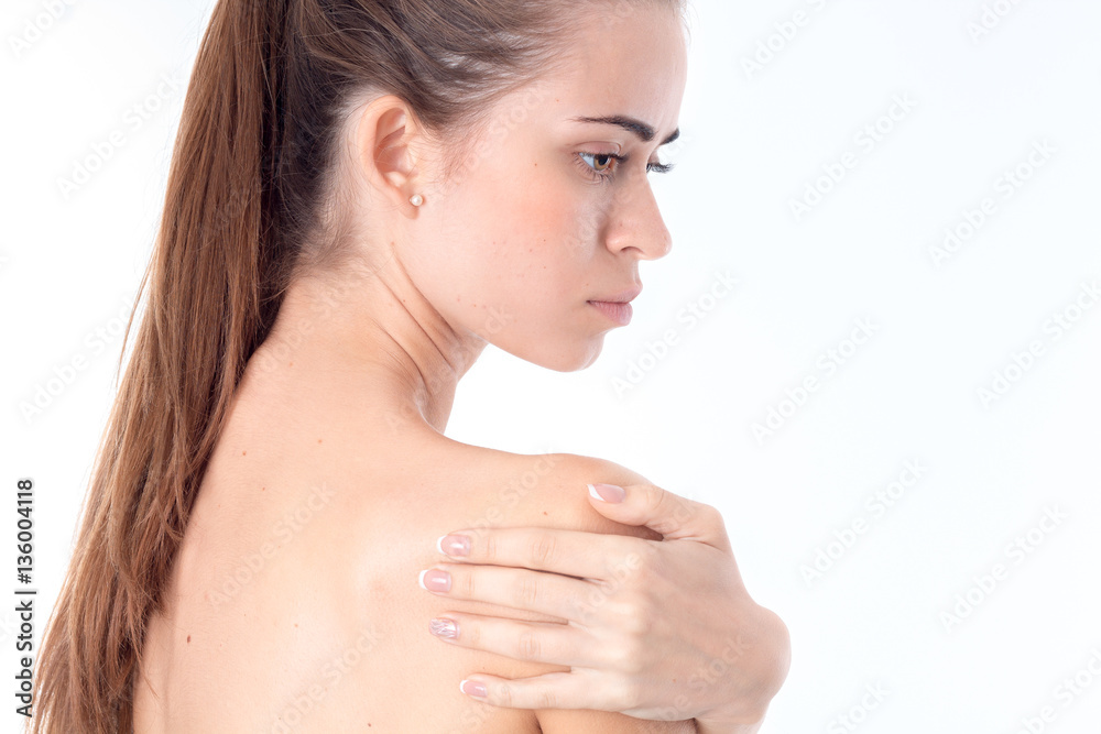 young girl turned sideways and keeps hand shoulders young girl turned sideways and keeps hand shoulders
