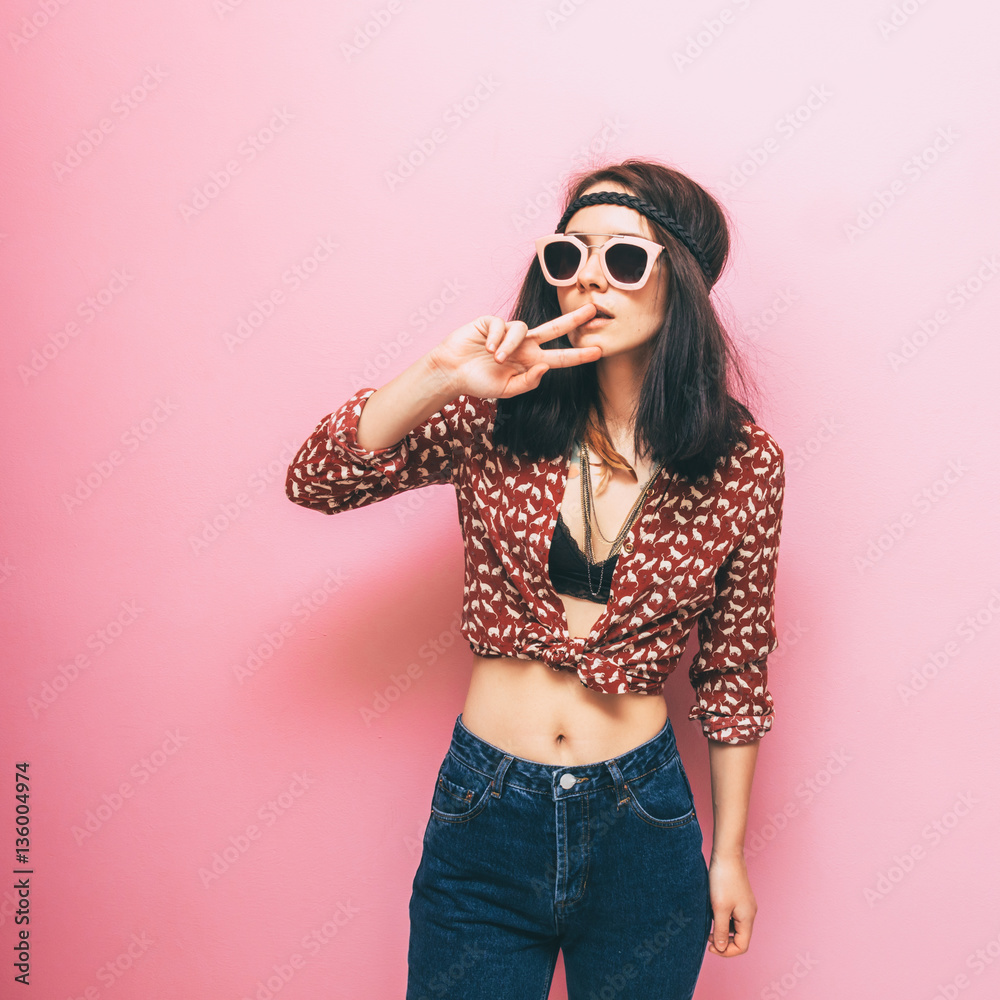 fashion girl shows the peace symbol in the trend clothes. nostalgia. hippie  style Stock-Foto | Adobe Stock