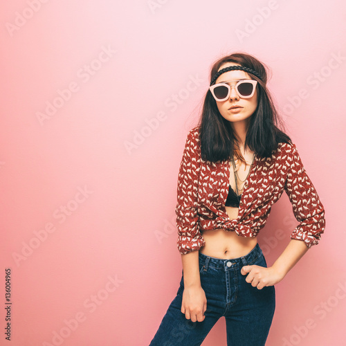 Lady in a hippie style is in fashion pose. Trendy clothes. Pastels and minimalism.