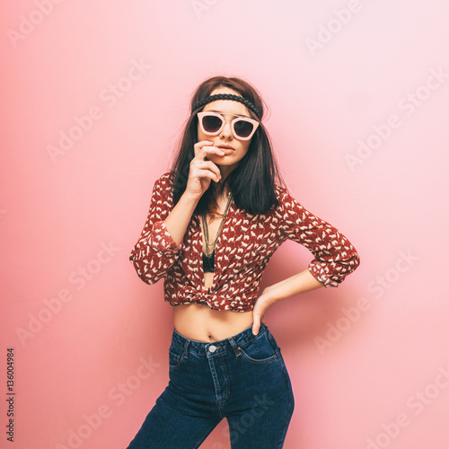 Beautiful woman in shirt and jeans stands in a possible position. Hippie trend and vintage. Pastel colors. © Katya Havok