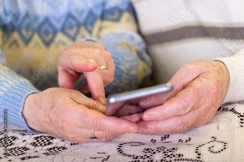 Elderly hands holding a smartphone