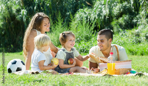 European familywith kids having picnic