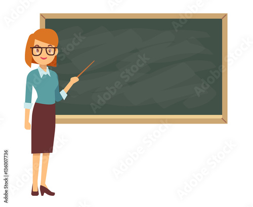 Young female teacher on lesson at blackboard in classroom