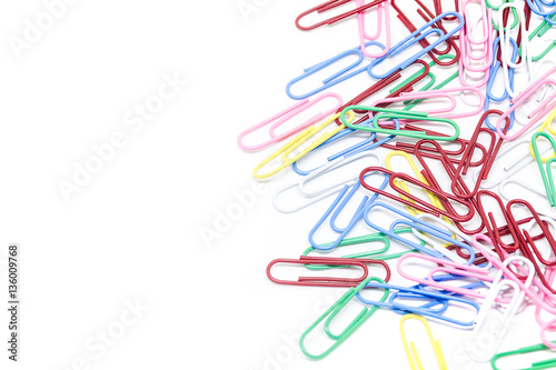 multi-colored paper clips on white background