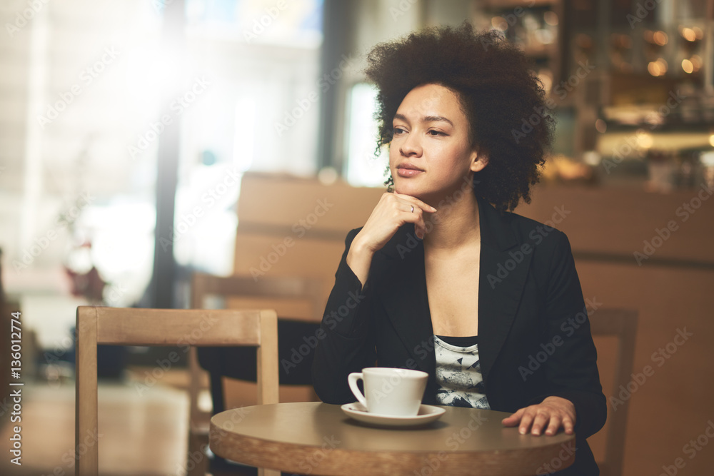 Mixed race, African American woman drinking coffee in cafe Mixed race, African American woman drinking coffee in cafe
