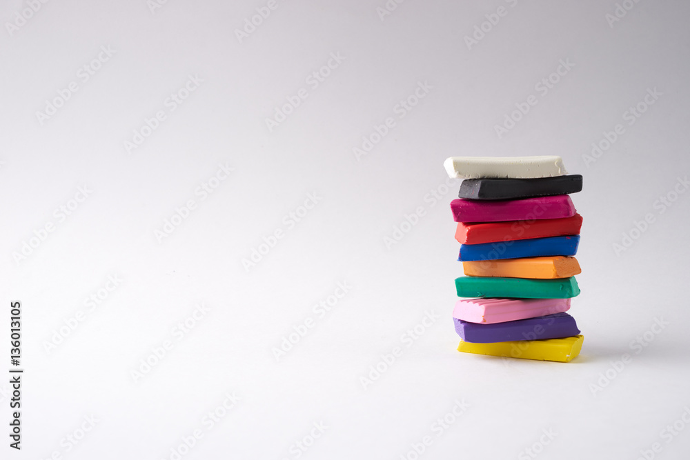 Colorful soft plasticine bars in pyramid isolated on white background with copy space. Colorful soft plasticine bars in pyramid isolated on white background with copy space.
