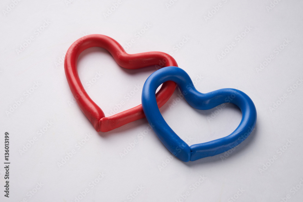 Red and blue plasticine heart. Isolated on white background Red and blue plasticine heart. Isolated on white background