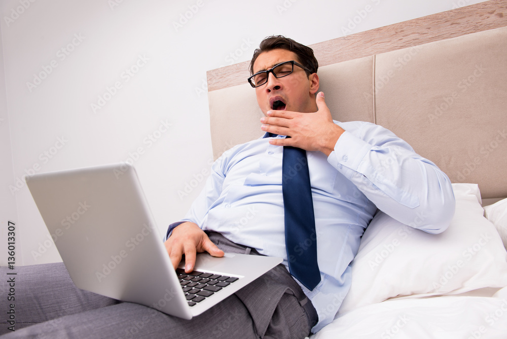 Businessman working in the bed at home Businessman working in the bed at home