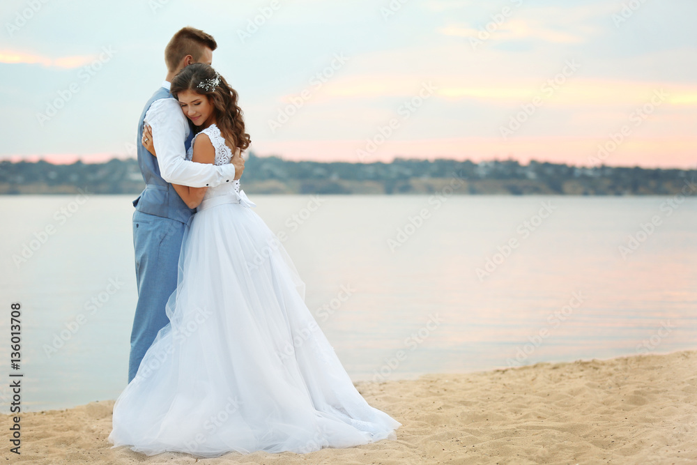 Beautiful wedding couple near river