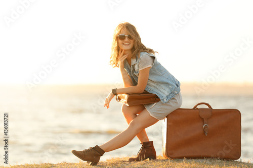 Young woman sitting on suit...