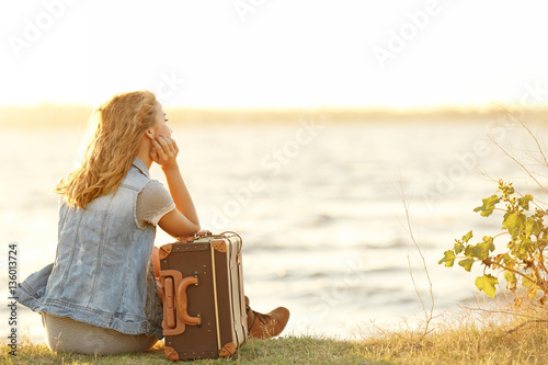 Young woman with suitcase s...