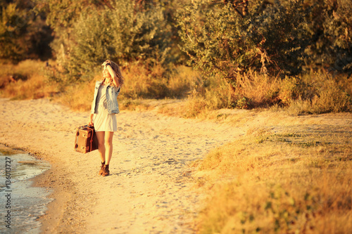 Young woman with suitcase w...