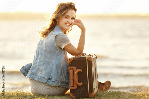 Young woman with suitcase s...