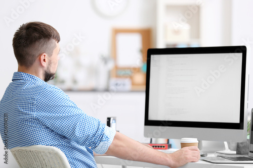 Handsome young programmer w...