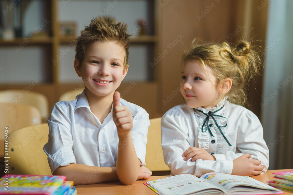 Fototapeta premium Children learning and doing homework in school classroom