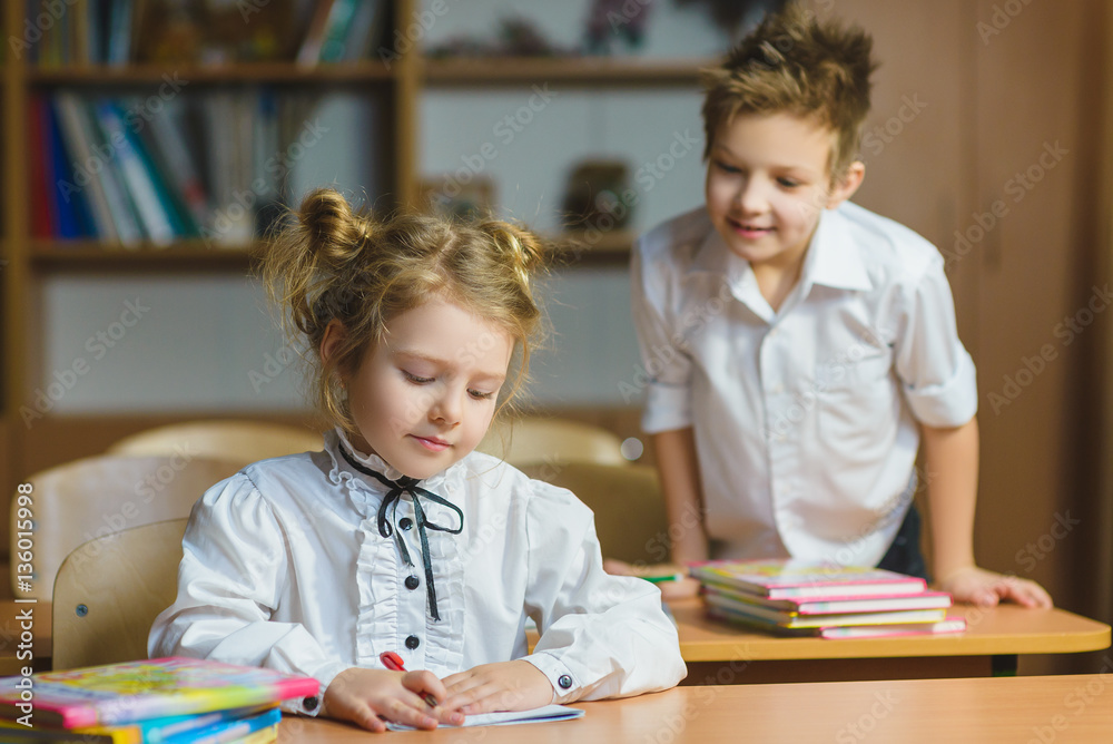 Children learning and doing homework in school classroom Children learning and doing homework in school classroom