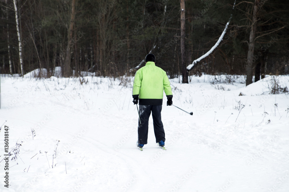 Skier rides and leads a healthy lifestyle in the winter forest