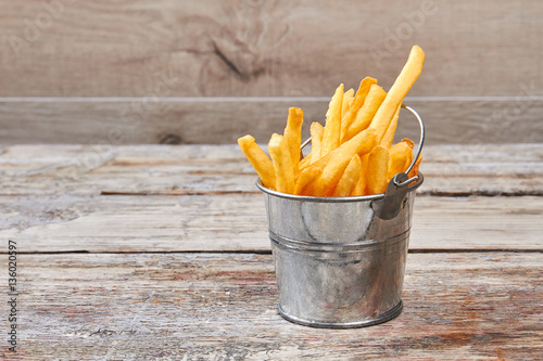 French fries in metal bucket.