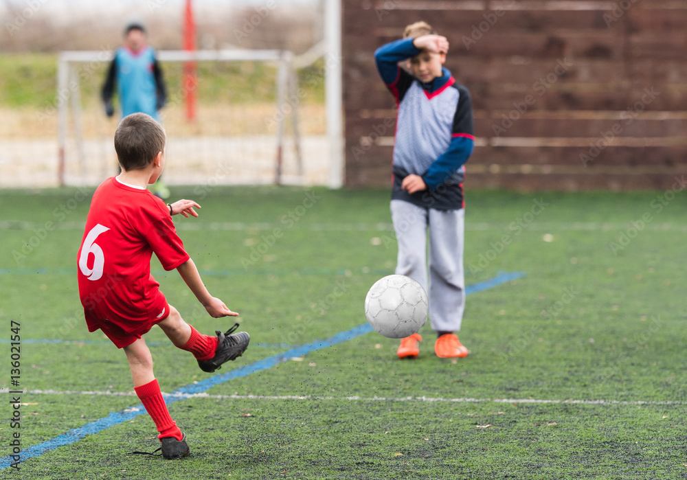 Boy kicking soccer ball