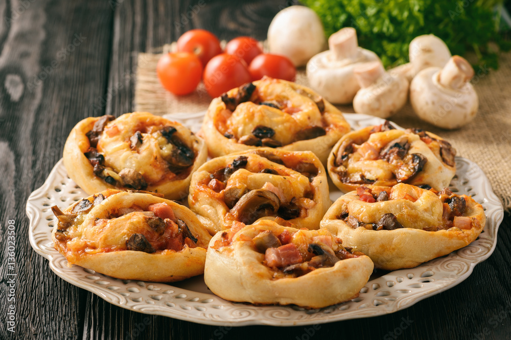 Pizza rolls with tomato sauce, bacon, mushrooms and cheese. Pizza rolls with tomato sauce, bacon, mushrooms and cheese.
