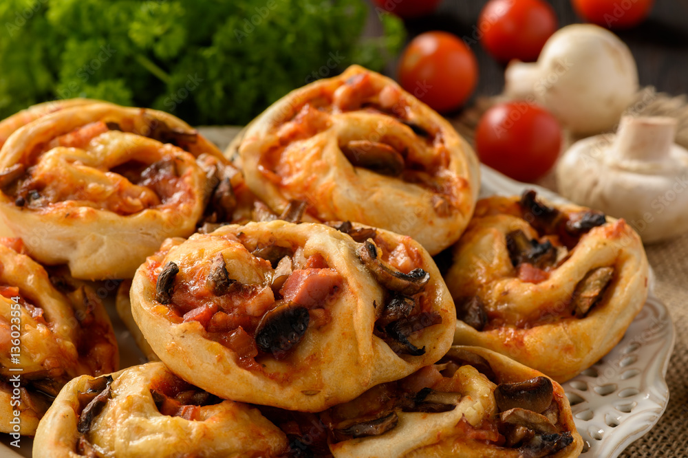 Pizza rolls with tomato sauce, bacon, mushrooms and cheese. Pizza rolls with tomato sauce, bacon, mushrooms and cheese.