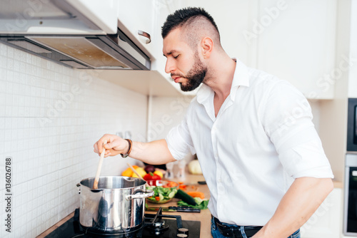 handsome man cooking and boiling pasta. healthy lifestyle details