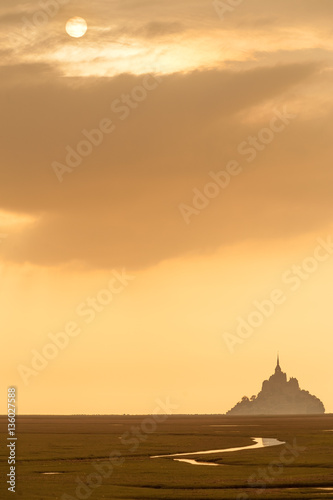 Silhouette of famous Mont Saint Michel on Normandy coast at sunset  France  