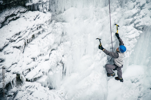 Photography men climbed a frozen waterfall, icicle