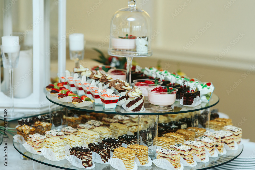 Cold and baked desserts stand served on glass dish