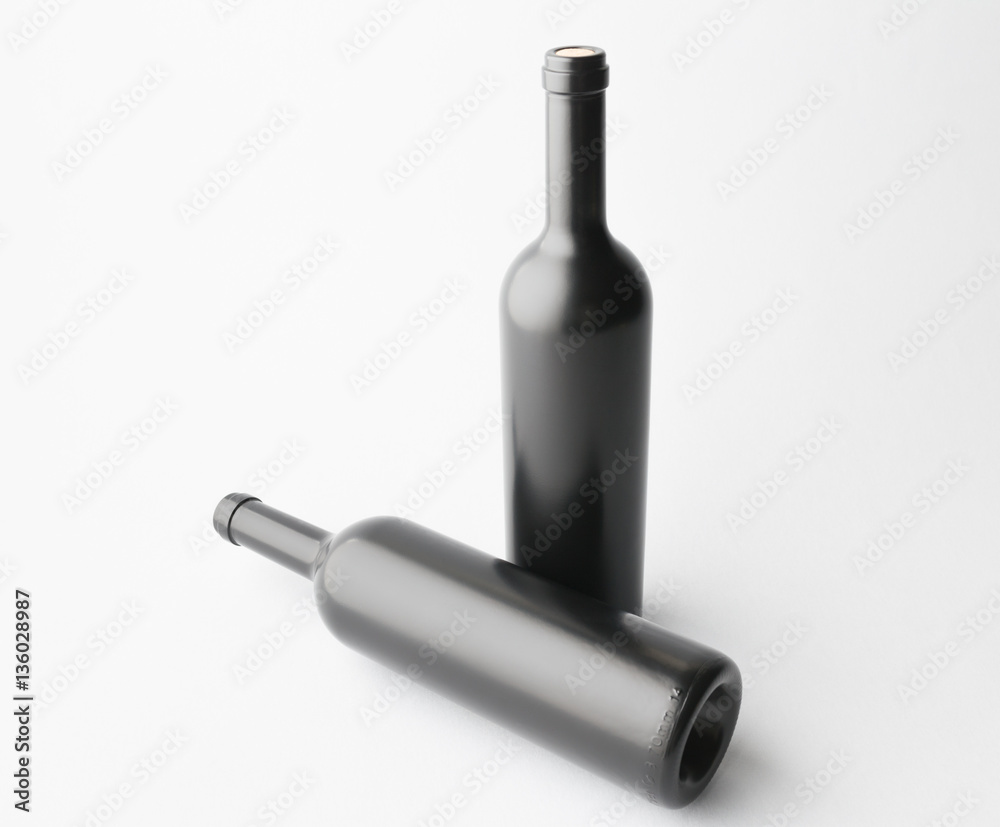 Two wine bottle are standing on gray background