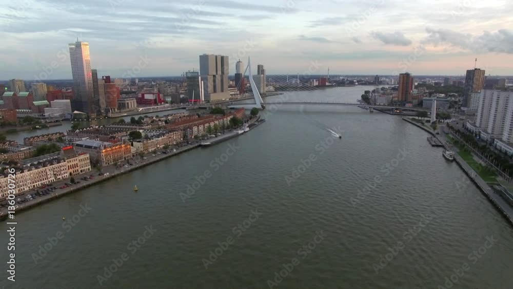 Aerial panorama of Rotterdam on the banks of the river with Erasmus Bridge over it, Netherlands. Evening scene Aerial panorama of Rotterdam on the banks of the river with Erasmus Bridge over it, Netherlands. Evening scene