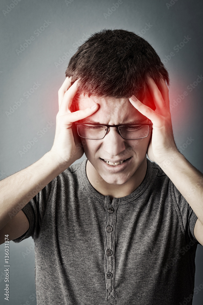 Frustrated teen with a headache Frustrated teen with a headache